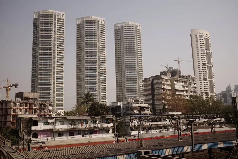 High-rise residential towers rising above older low-rise buildings in Mumbai